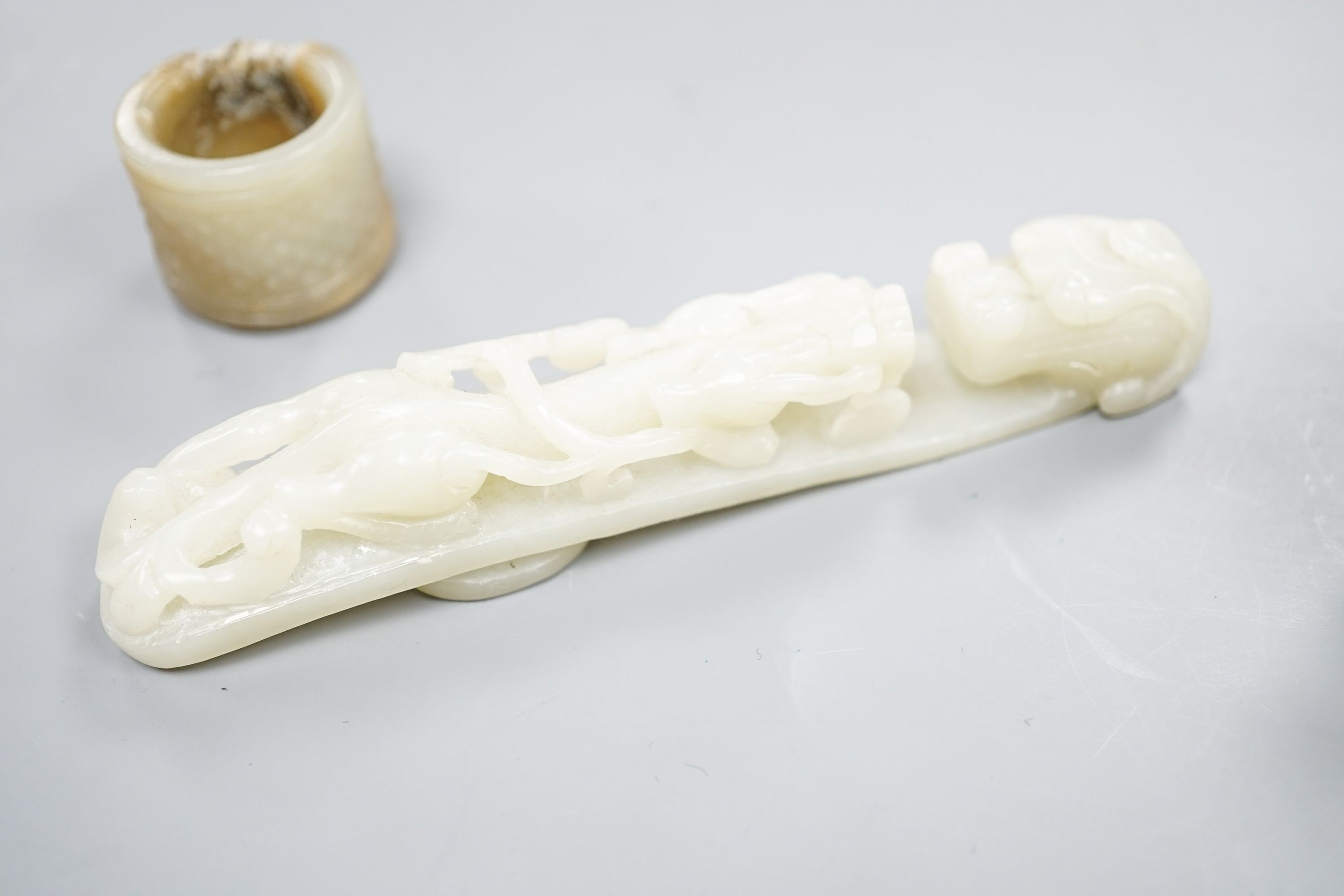 A Chinese jade belt hook, 12.5cm an archer's ring and figure, a stone cup and a glass snuff bottle